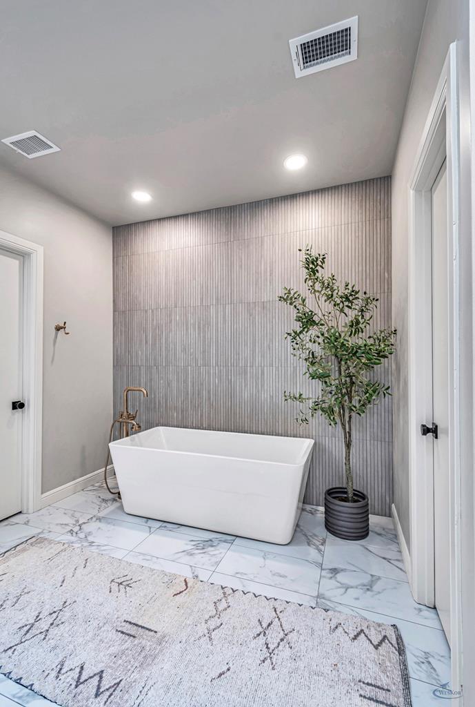 spacious yet beautiful bathtub with tile accent wa